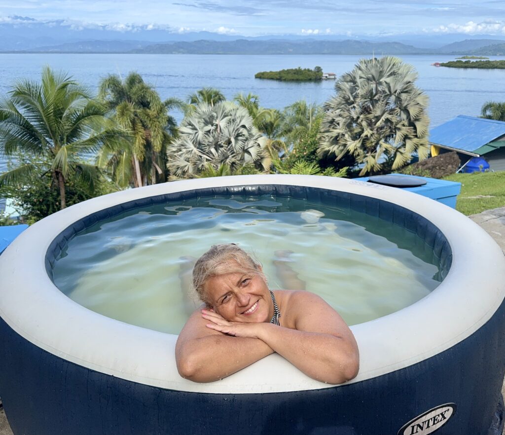 Guest resting in hot tub at Misty Moonlight Villa